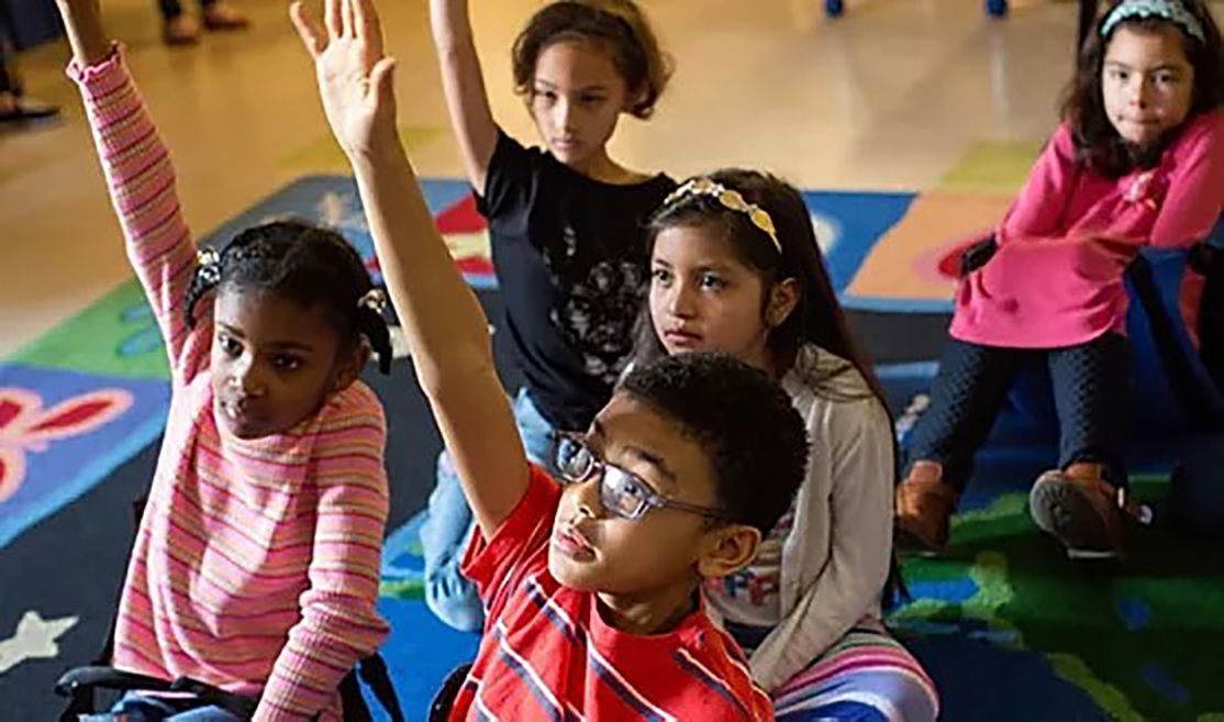 Minority Children with Autism raising hands