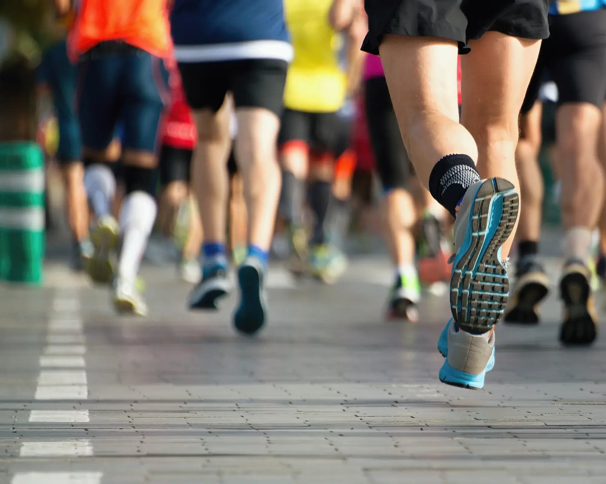 A group of people running on the street.